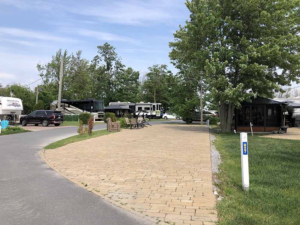 A paved pull thru RV site at CAMPING LA CLE DES CHAMPS RV RESORT