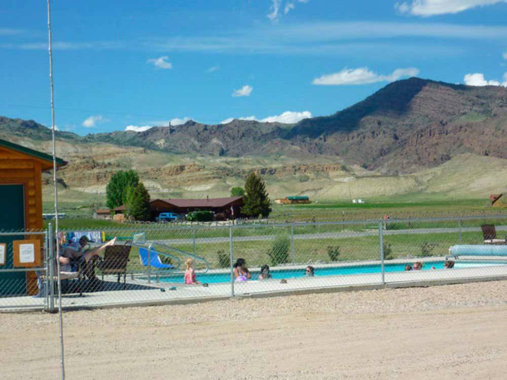 View of the swimming pool and hills at YELLOWSTONE VALLEY INN & RV PARK
