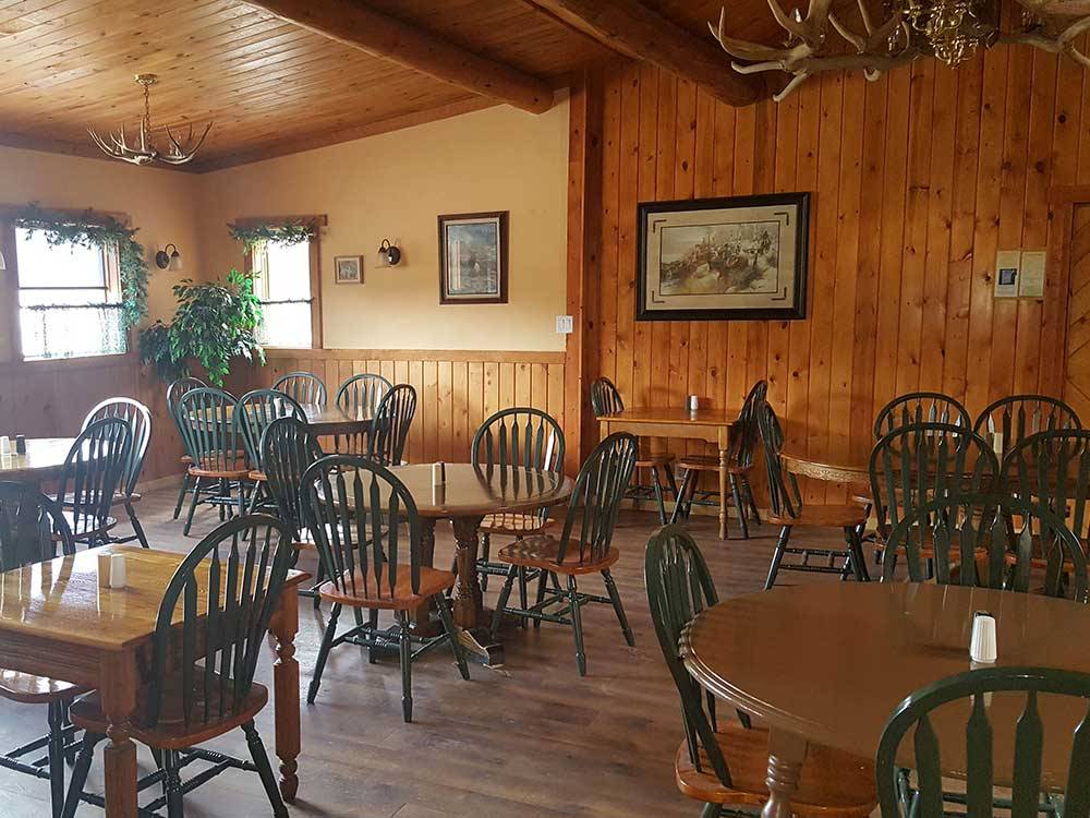 Tables and chairs in the restaurant at YELLOWSTONE VALLEY INN & RV PARK