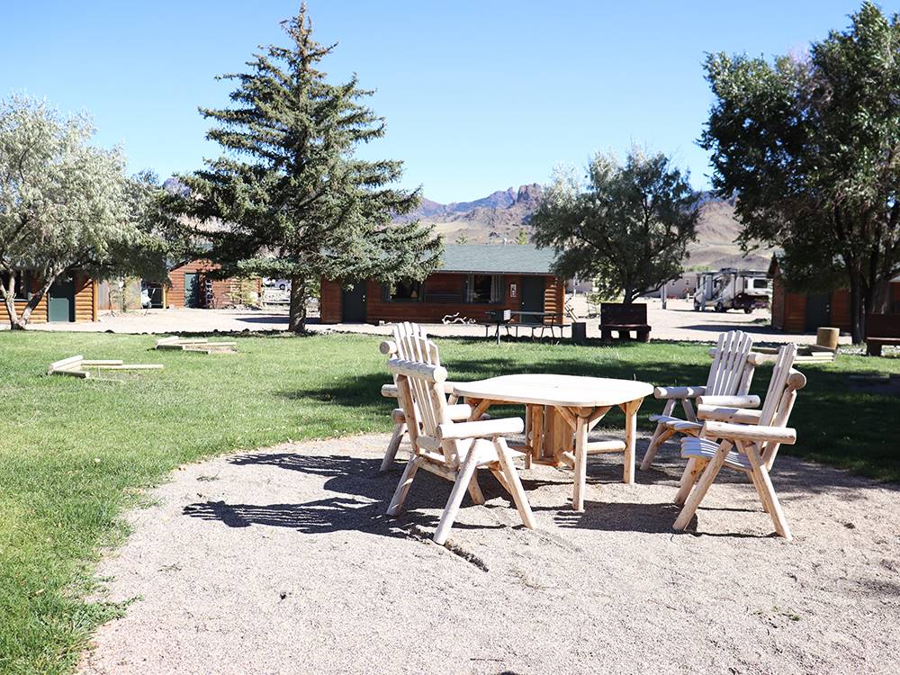 Chairs and table in the sand at YELLOWSTONE VALLEY INN & RV PARK