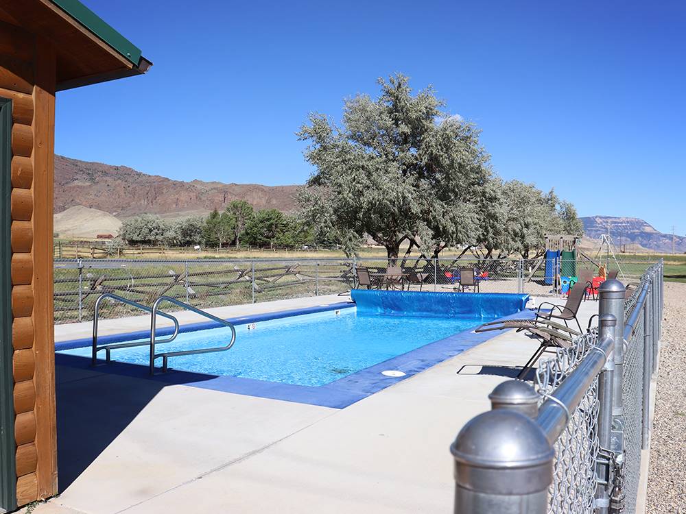 The fenced in swimming pool at YELLOWSTONE VALLEY INN & RV PARK