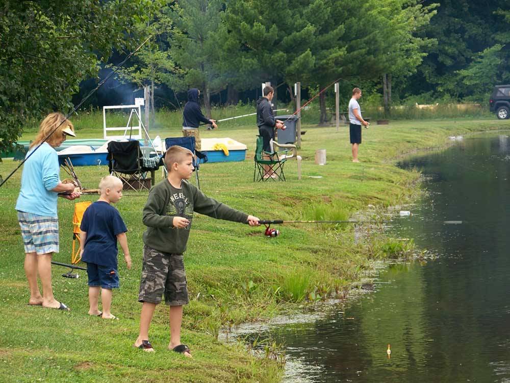 A group of people fishing at AMERICAN WILDERNESS CAMPGROUND