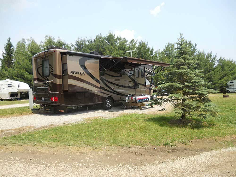 A motorhome in an RV site at AMERICAN WILDERNESS CAMPGROUND