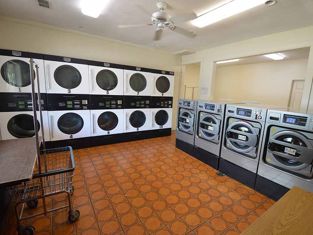 Laundry room with multiple washers and dryers at SAN JACINTO RIVERFRONT RV PARK