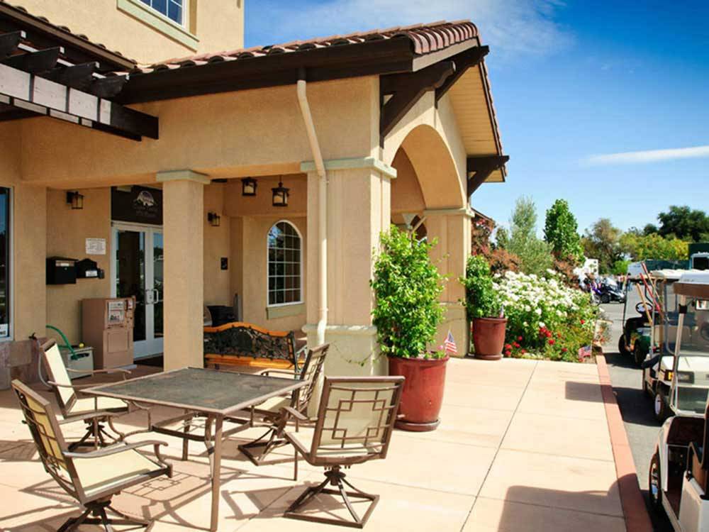 Large spanish style main office with golf carts out front at COYOTE VALLEY RV RESORT