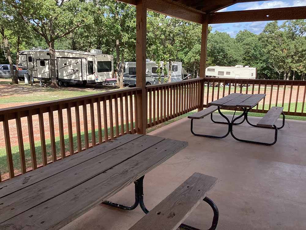 A pair of picnic benches on the deck at OAK GLEN RV PARK