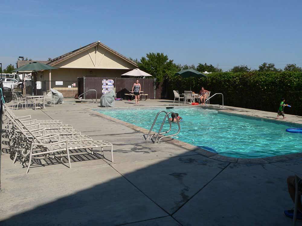 People swimming in pool at FLAG CITY RV RESORT