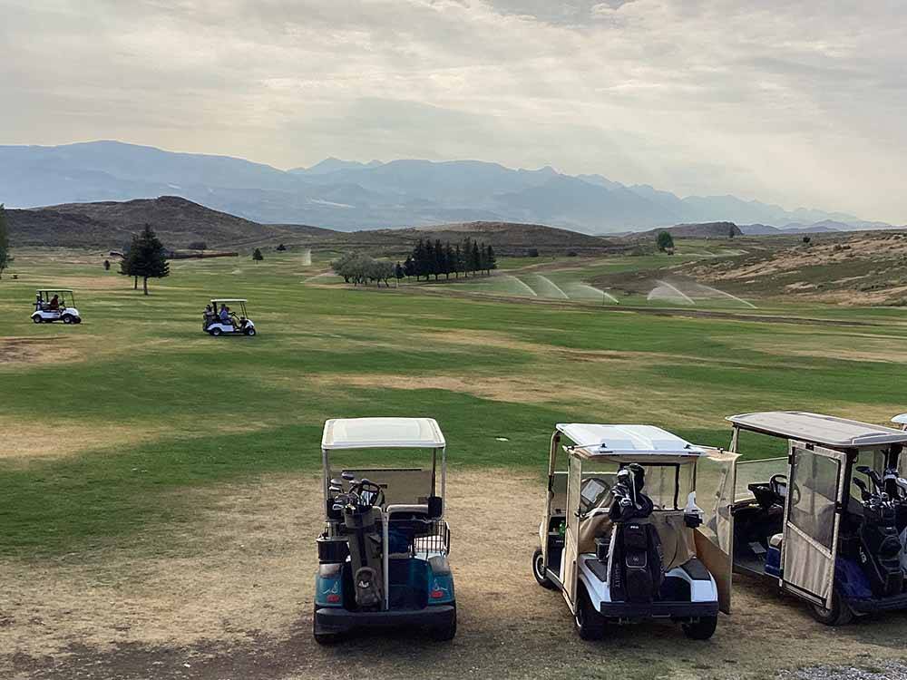 A row of golf carts at the golf course at CHALLIS GOLF COURSE RV PARK