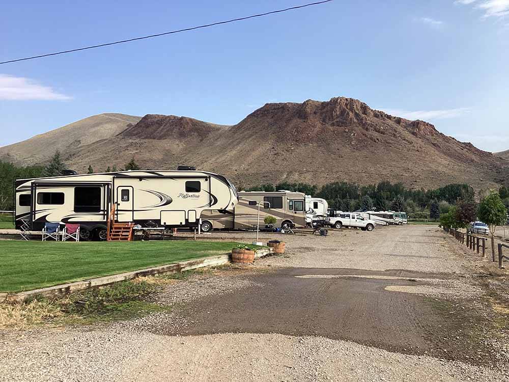 The gravel road with occupied RV sites at CHALLIS GOLF COURSE RV PARK