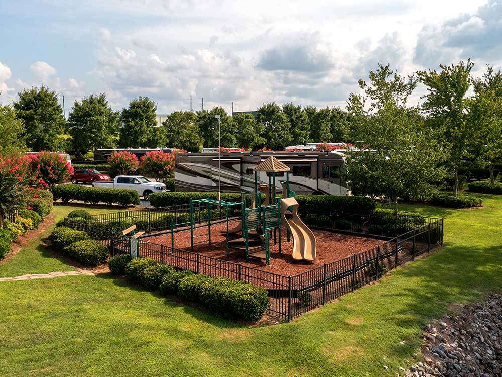 Playground with slides and campers in background at TWO RIVERS LANDING RV RESORT