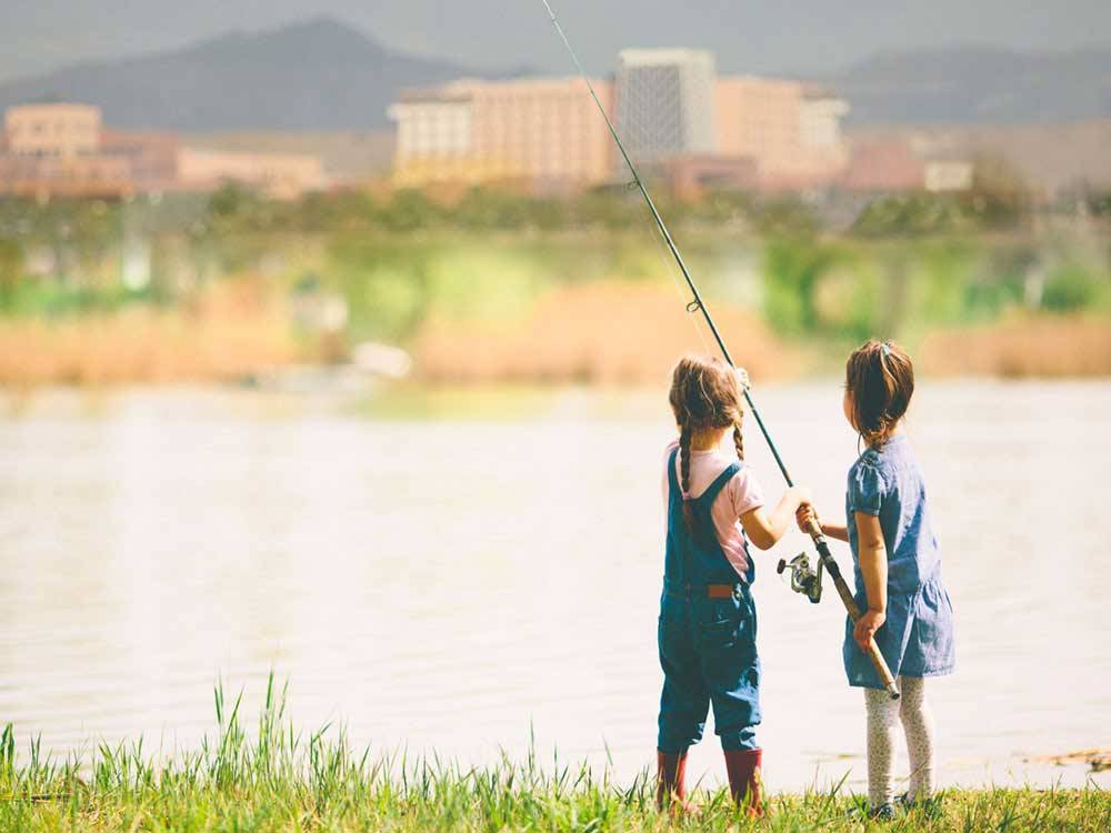 Two children fishing in the lake at ISLETA LAKES & RV PARK