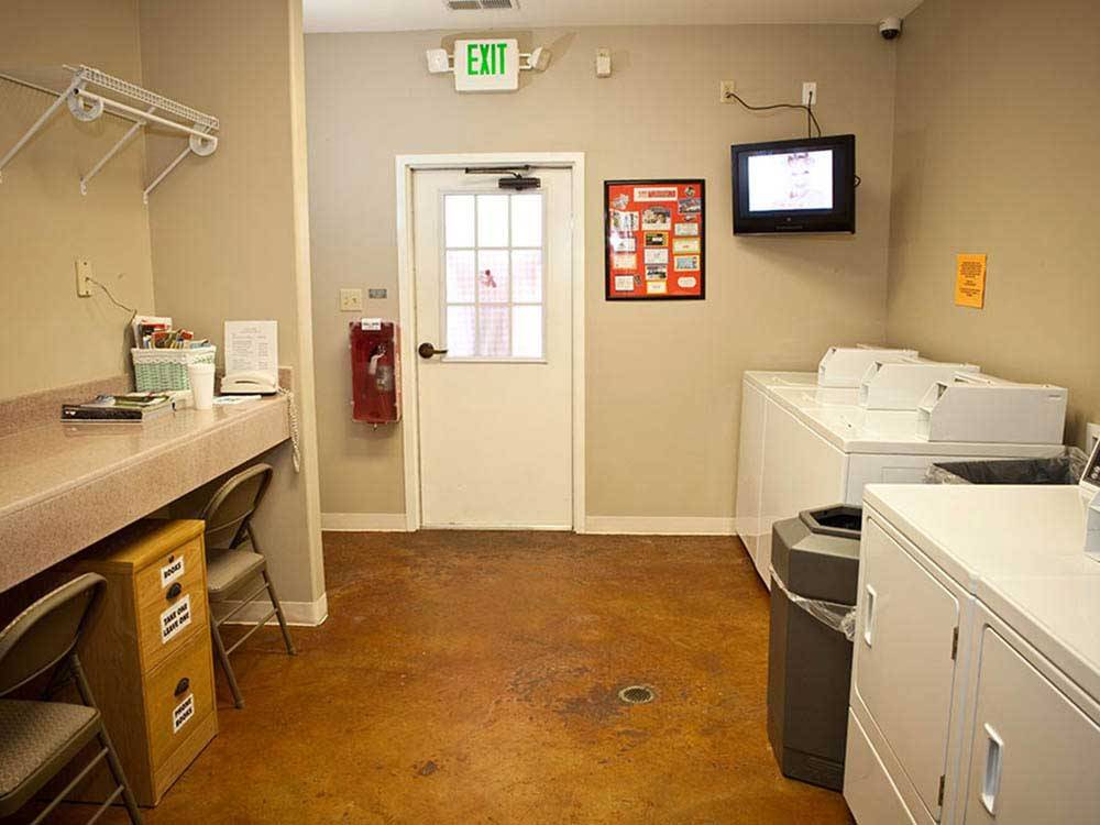 Laundry room with washer and dryers at EZ DAZE RV PARK