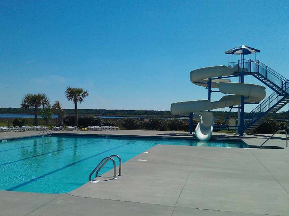 The swimming pool with a large slide at WHITE OAK SHORES CAMPING & RV RESORT