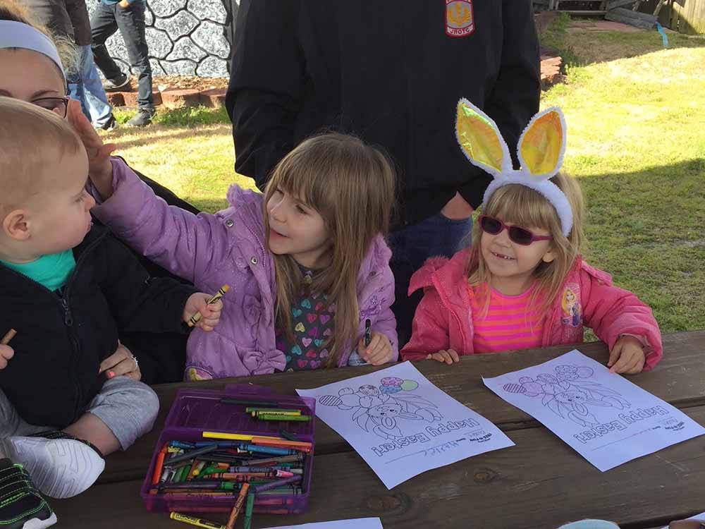 A couple of girls coloring at FOUR OAKS LODGING & RV RESORT