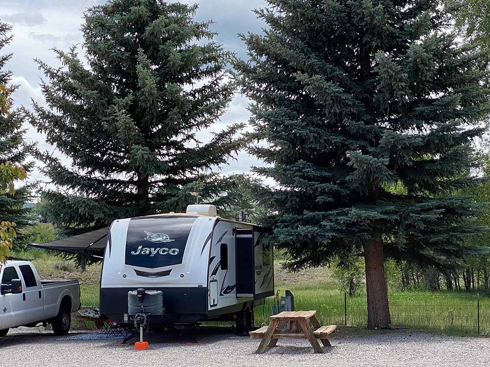 A trailer in a gravel RV site at SKY MOUNTAIN RESORT RV PARK