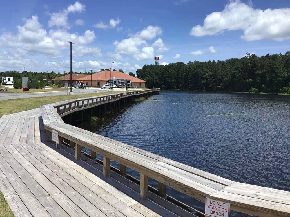 A wooden walkway by the water at COASTAL GEORGIA RV RESORT