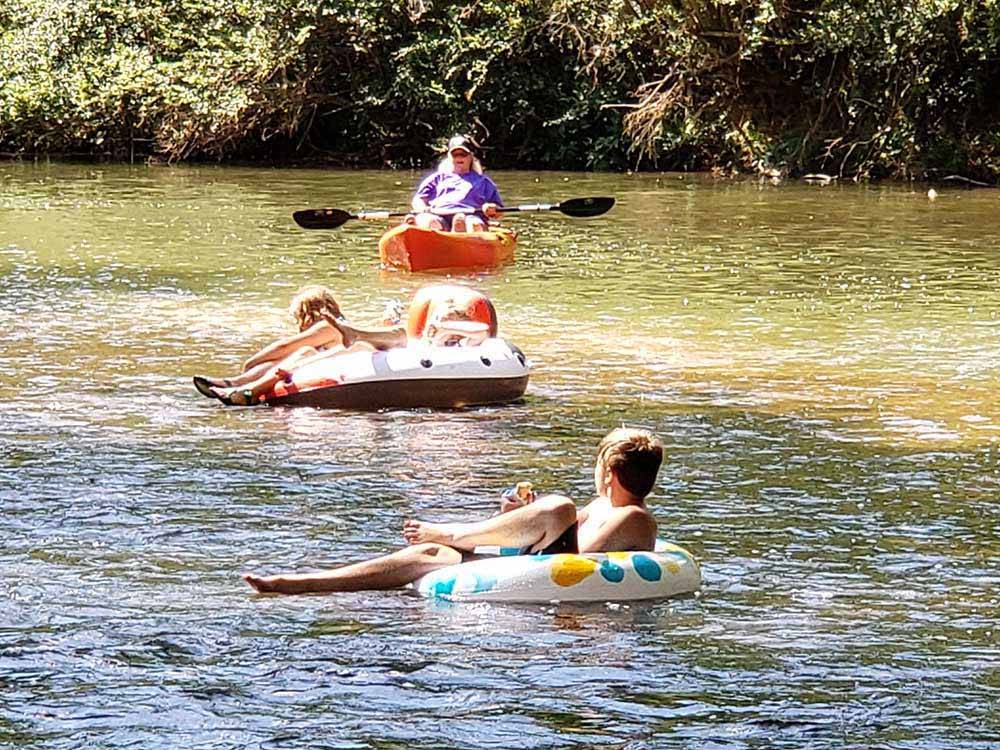 Kids floating in inner tubes on the river at CEDAR CREEK RV & OUTDOOR CENTER