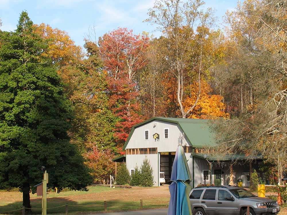 Barn-shaped building amid an autumn landscape at MADISON VINES RV RESORT & COTTAGES
