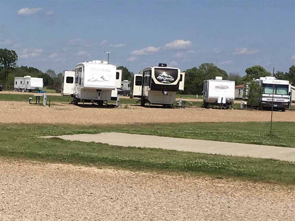 A row of RVs parked on gravel at SUNRISE RV PARK