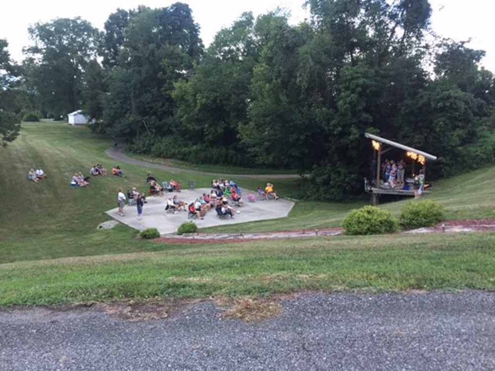 A group of people watching a band at FOLLOW THE RIVER RV RESORT