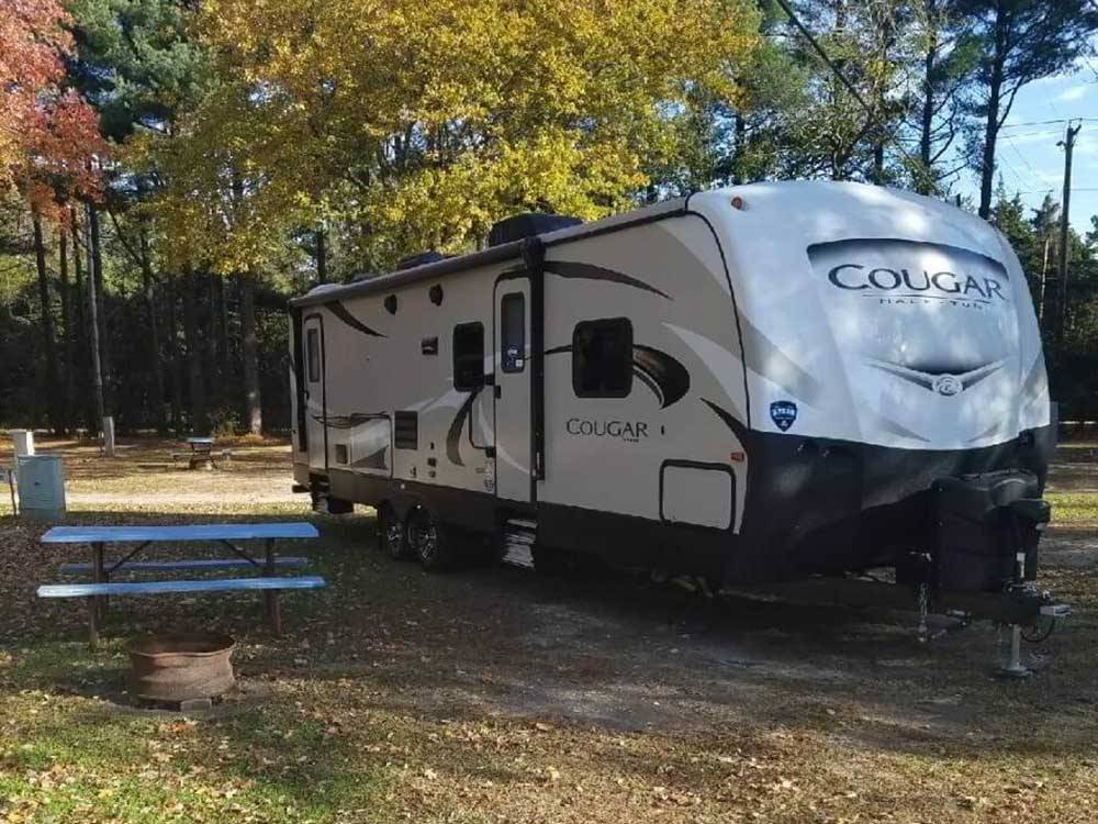 A travel trailer parked at a campsite at ATLANTIC BLUEBERRY RV PARK