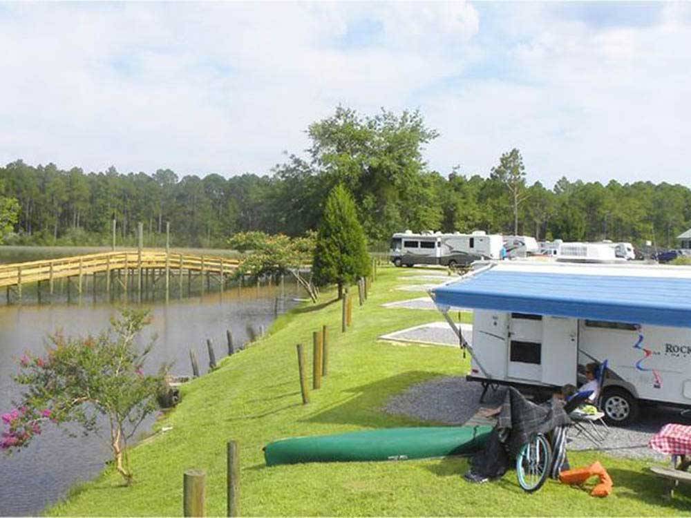 Waterfront RV sites with grass at AVALON LANDING RV PARK