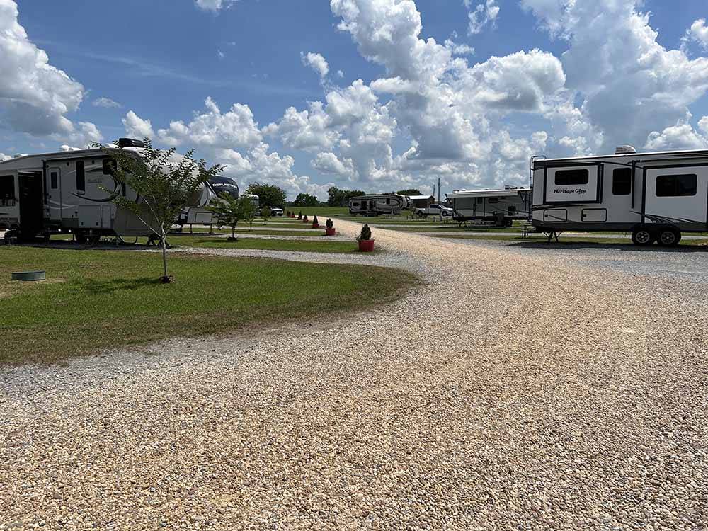 Planters in front of gravel RV sites at MONTGOMERY SOUTH RV PARK & CABINS