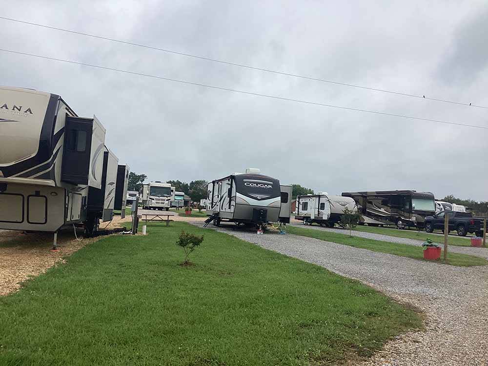 Trailers and motorhomes parked in gravel sites at MONTGOMERY SOUTH RV PARK & CABINS