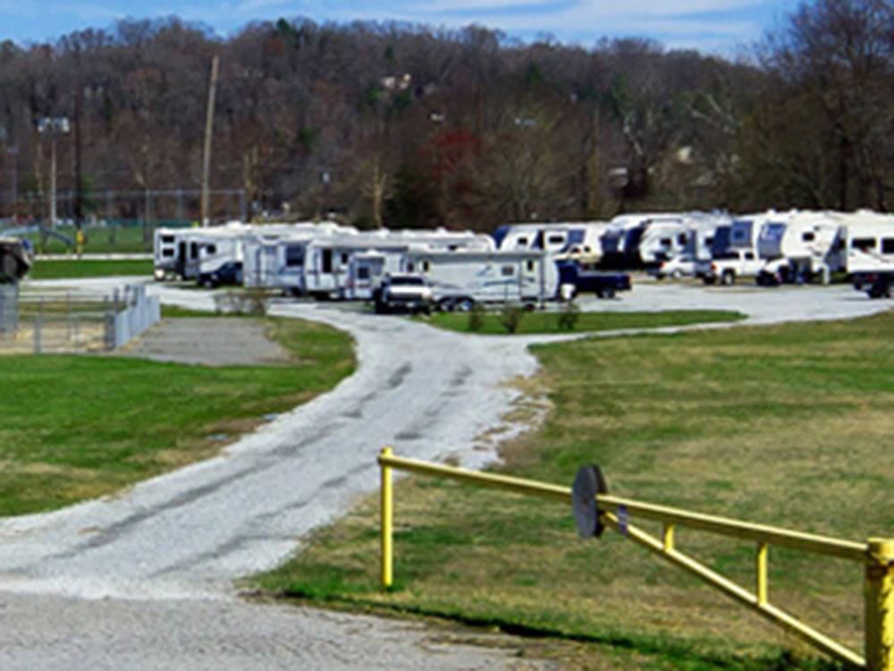 Several RVs parked behind a yellow gate at RIVERSIDE GOLF & RV PARK
