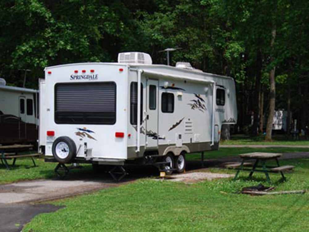 Fifth wheel parked in a campsite at CHESAPEAKE CAMPGROUND