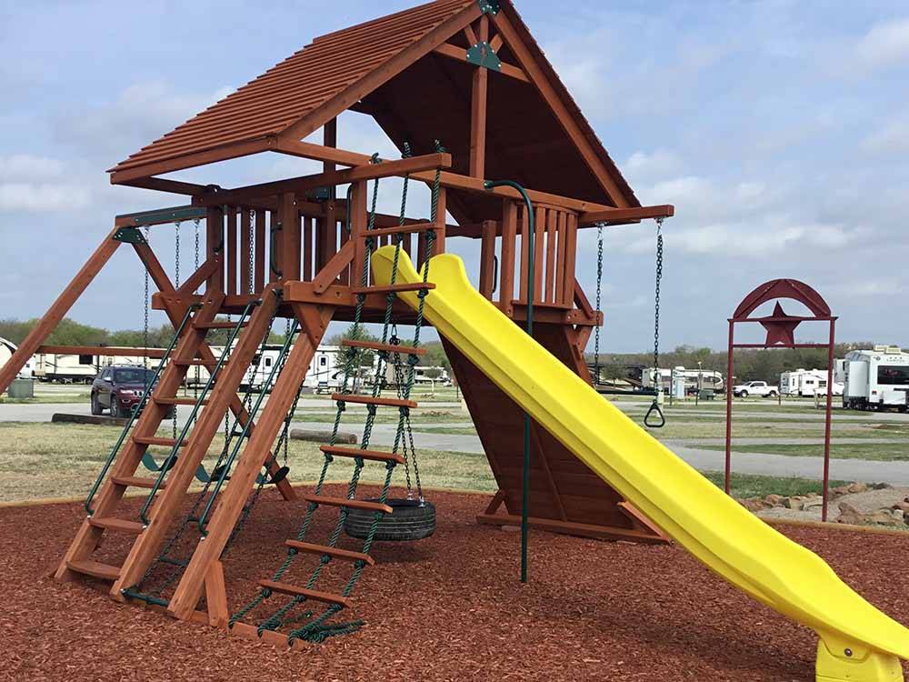Playground area with large slide at COFFEE CREEK RV RESORT & CABINS