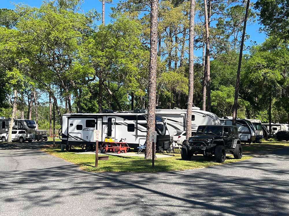 A row of RVs parked in paved sites at LAKE WALDENA RESORT