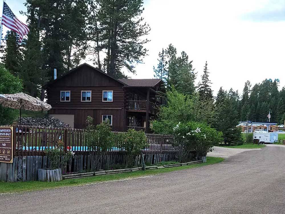 Two-story wooden building overlooks a pool at FISH'N FRY CAMPGROUND & RV PARK