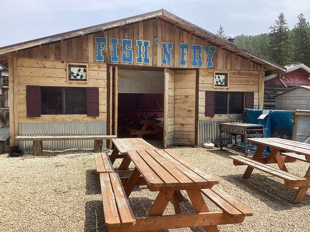Picnic benches in front of the restaurant at FISH'N FRY CAMPGROUND & RV PARK
