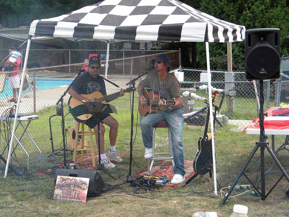 A couple of people playing guitar at CIRCLE CG FARM CAMPGROUND
