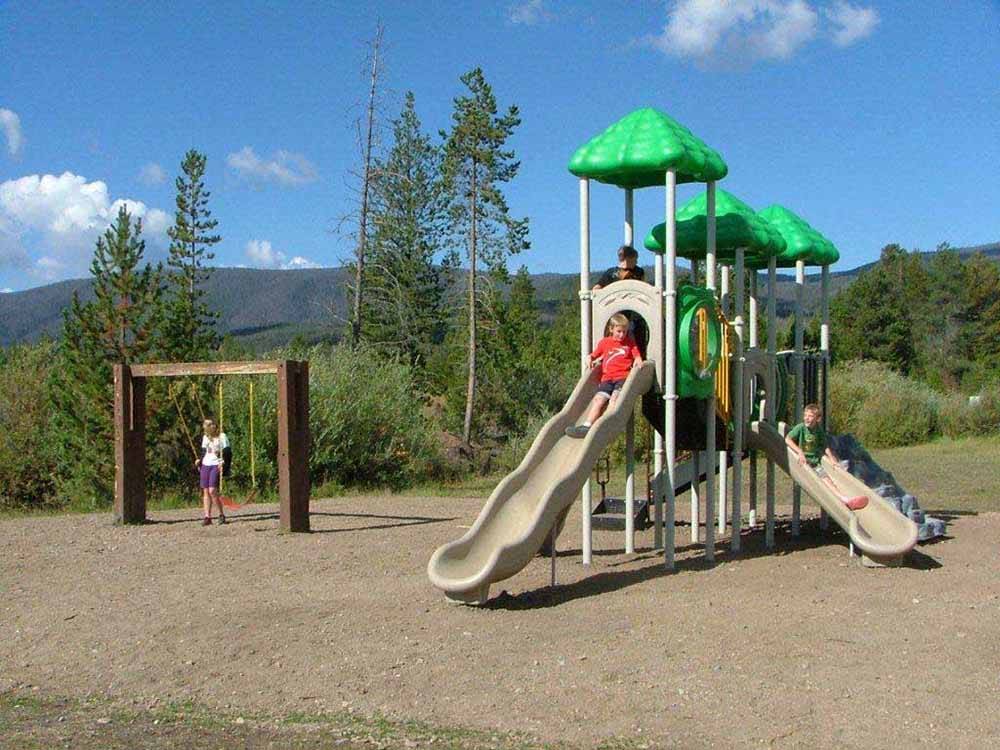 Kids playing on the playground equipment at WINDING RIVER RESORT