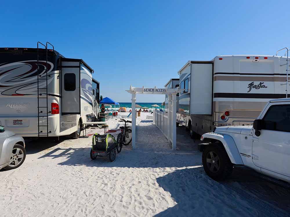 A couple of motorhomes on the sand at CAMPING ON THE GULF