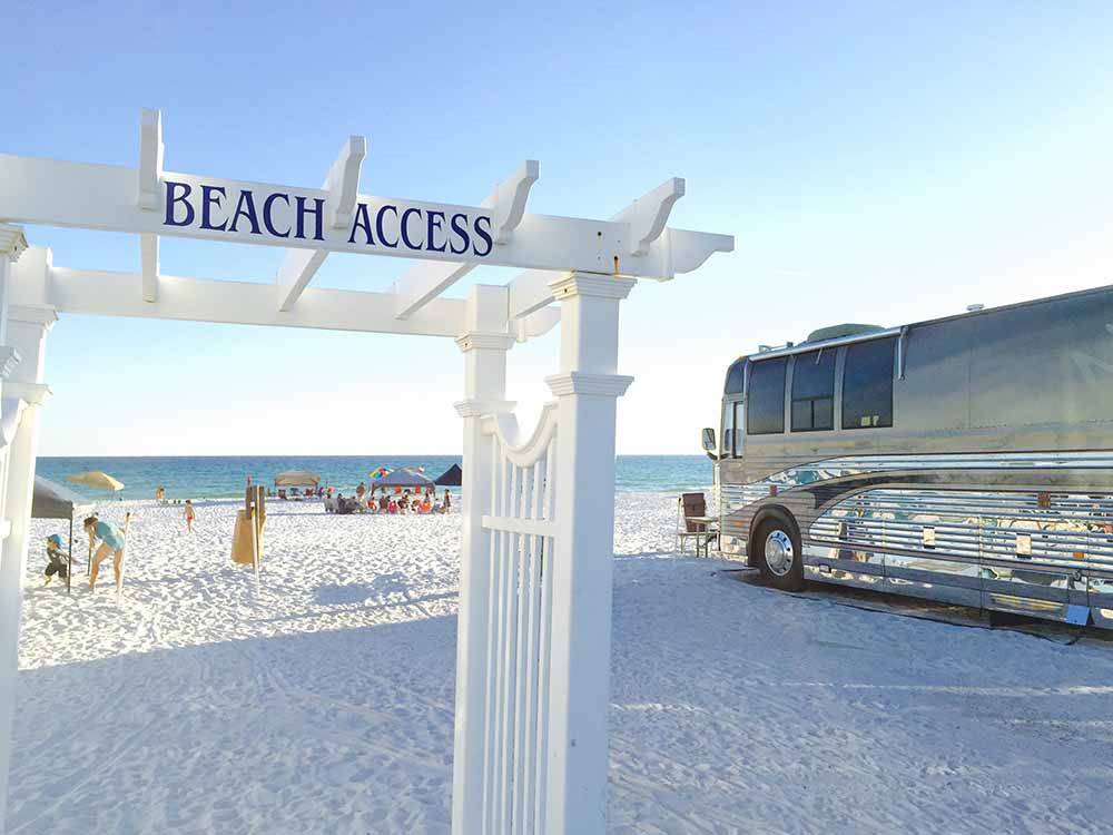A RV parked next to the beach access sign at CAMPING ON THE GULF