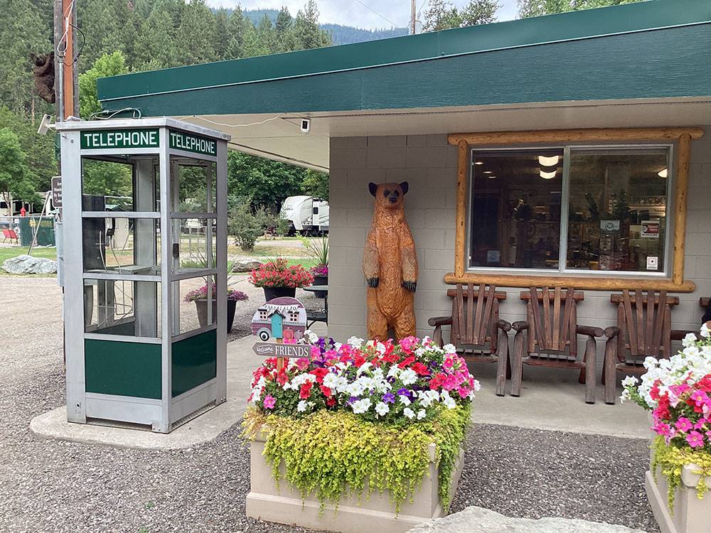 Campground office with telephone booth and bear statue at CAMPGROUND ST REGIS