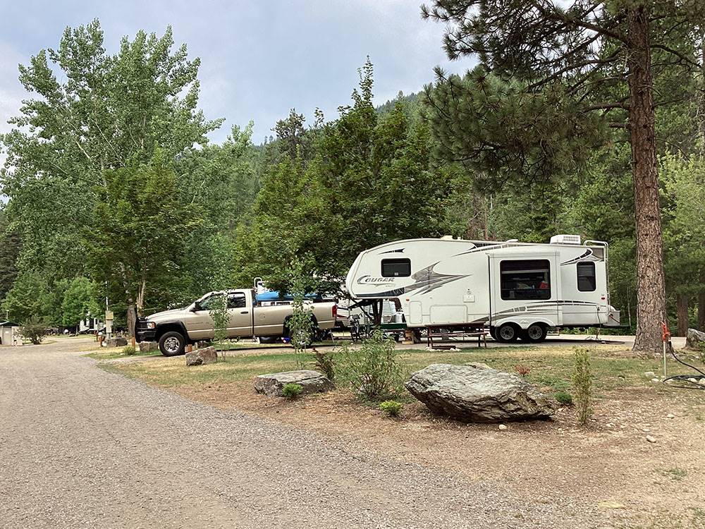 Fifth-wheel and tow vehicle in campsite at CAMPGROUND ST REGIS
