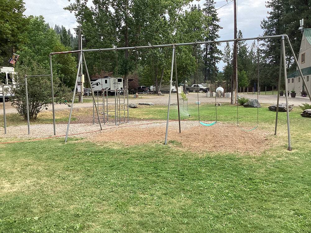 Swing set in grassy play area at CAMPGROUND ST REGIS