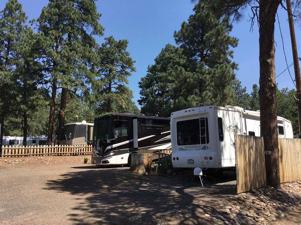 A couple of RVs in dirt RV sites at FLAGSTAFF RV PARK