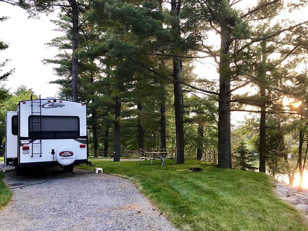 A motorhome in a gravel RV site at SID TURCOTTE PARK CAMPING AND COTTAGE RESORT