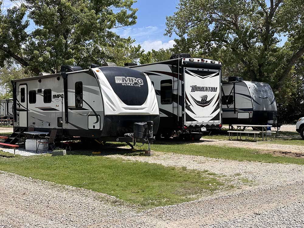 A row of travel trailers parked in sites at ALL SEASONS RV PARK
