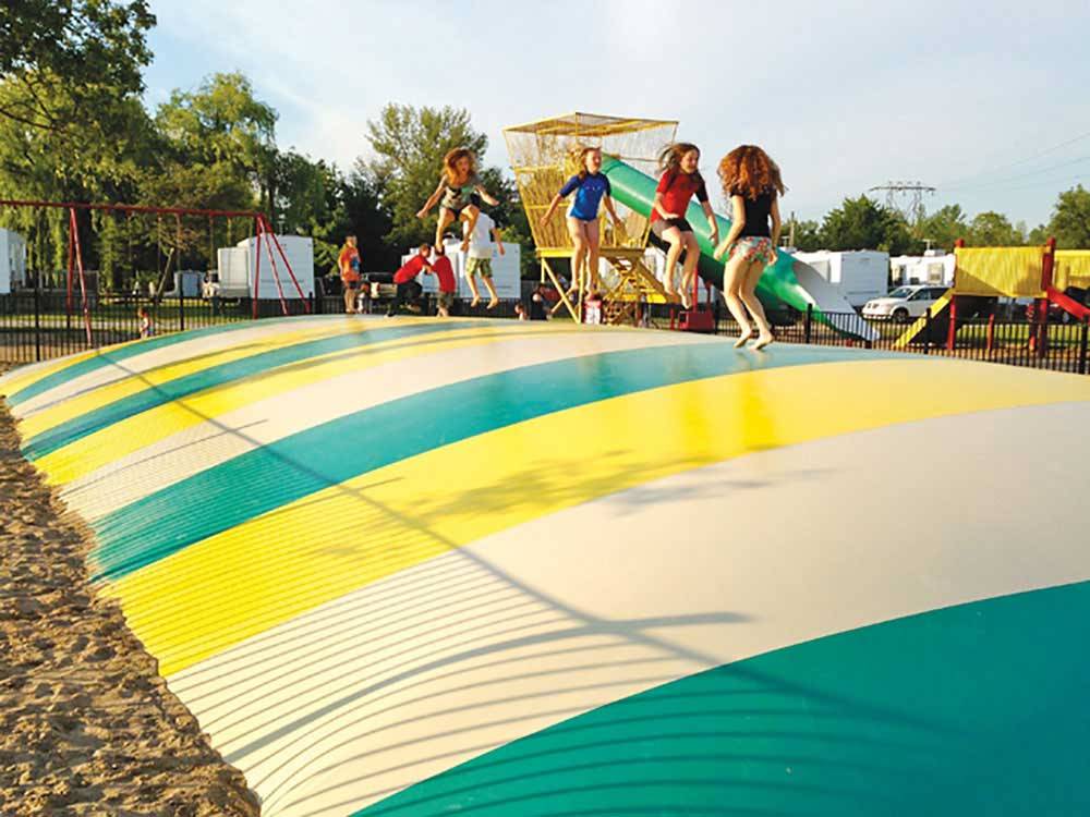 Playground with swing set at YOGI BEAR'S JELLYSTONE PARK CAMP-RESORT