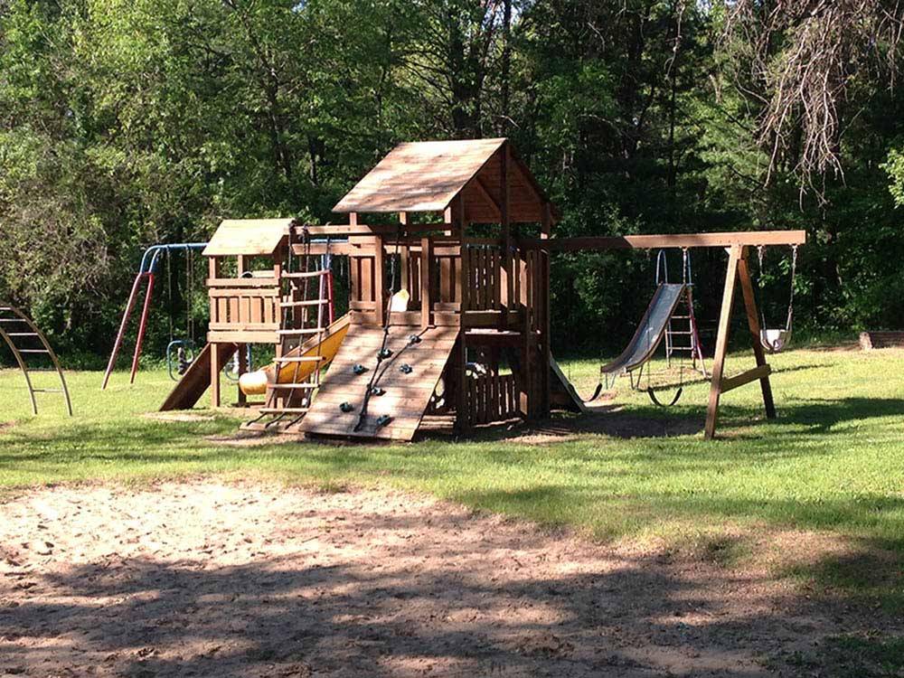 Playground with swing set at SHERWOOD FOREST CAMPING & RV PARK