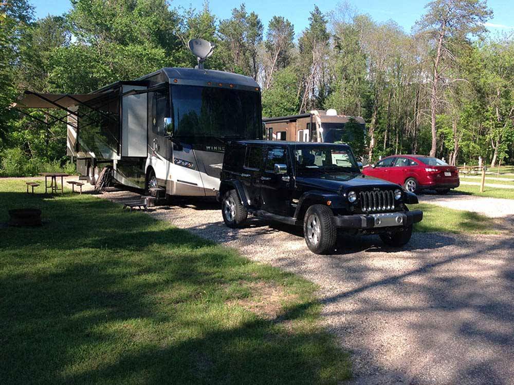 RVs camping at shady site at SHERWOOD FOREST CAMPING & RV PARK