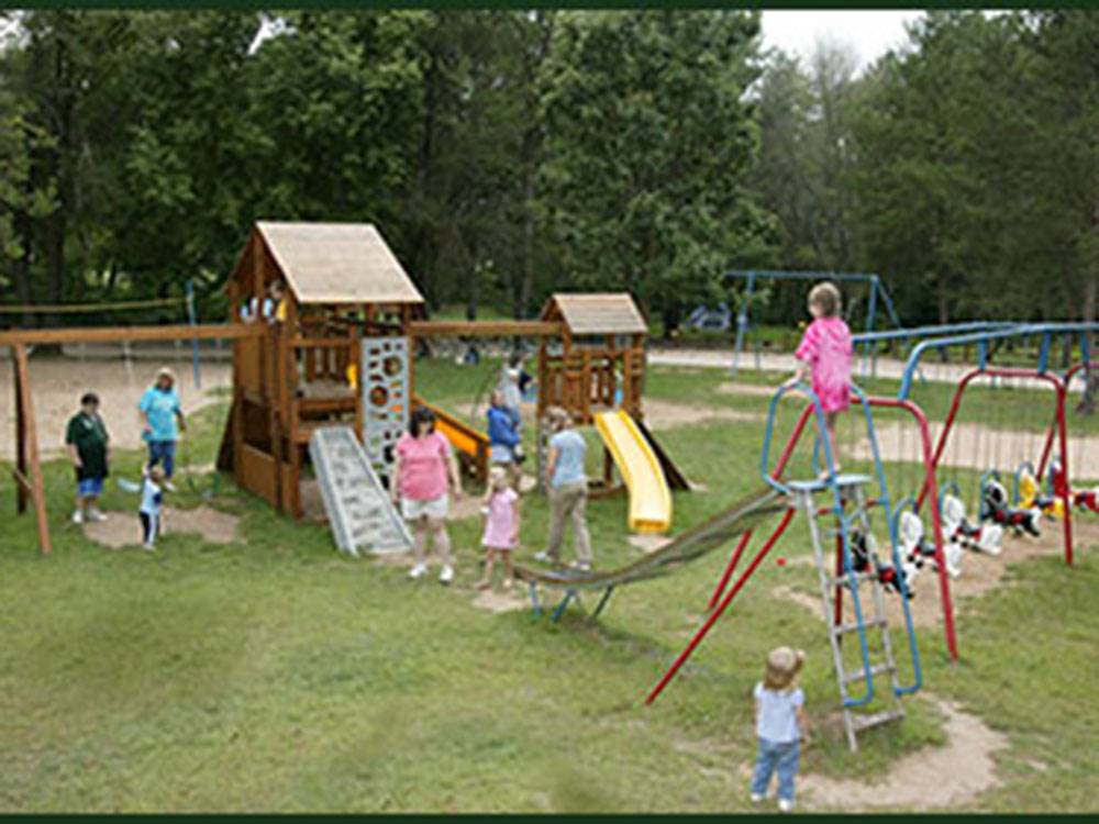 Families playing at the playground at SHERWOOD FOREST CAMPING & RV PARK
