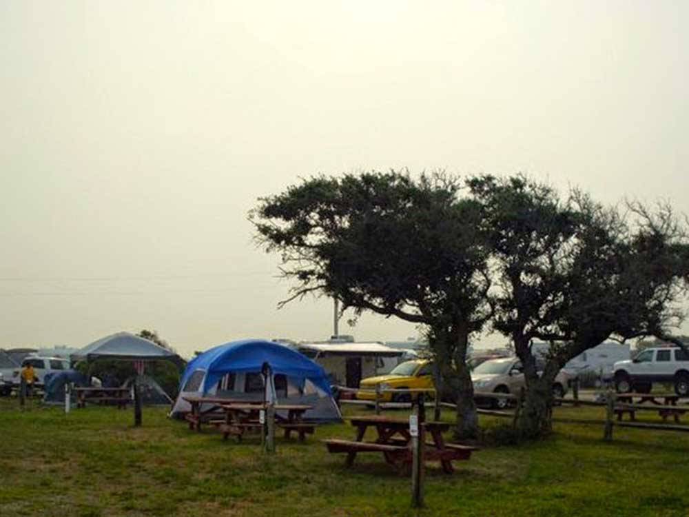 Picnic tables and a tent at HATTERAS SANDS CAMPGROUND