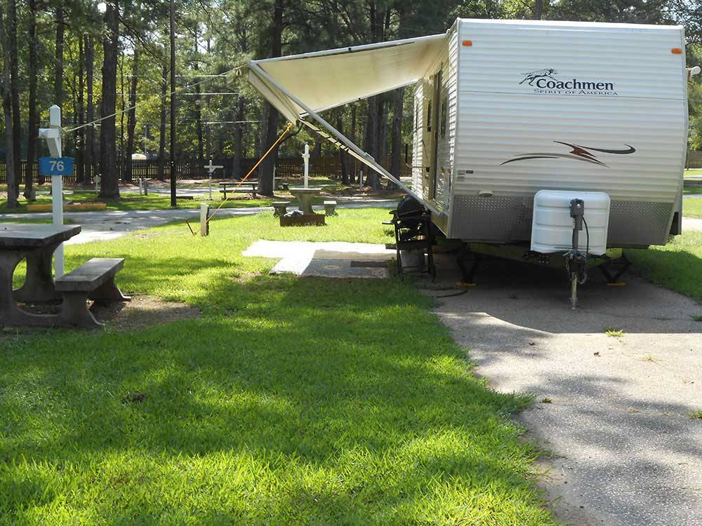 A travel trailer in a paved RV site at ALLATOONA LANDING MARINE RESORT